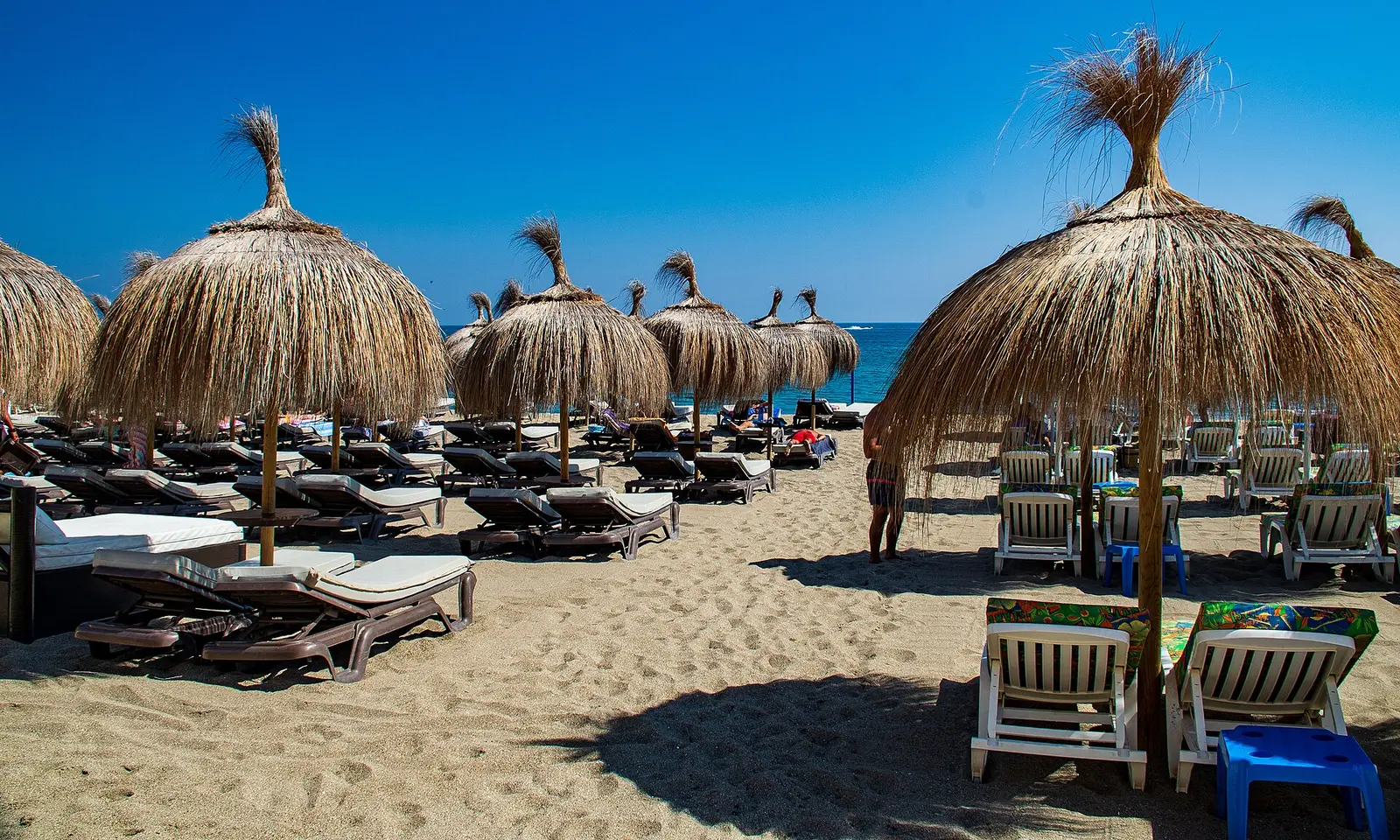 Het strand van Fuengirola met rieten parasols en ligbedden
